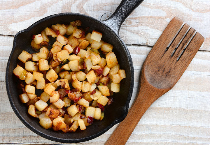 Crispy adobo potatoes in a cast iron skillet