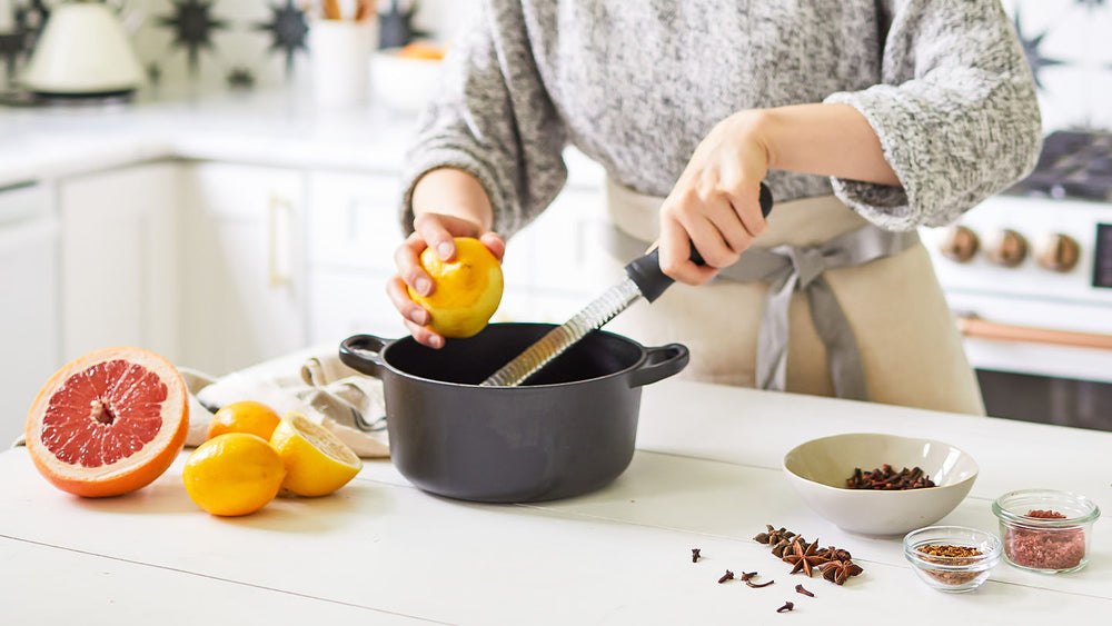 Woman grating lemon zest for simple recipes in her home kitchen.