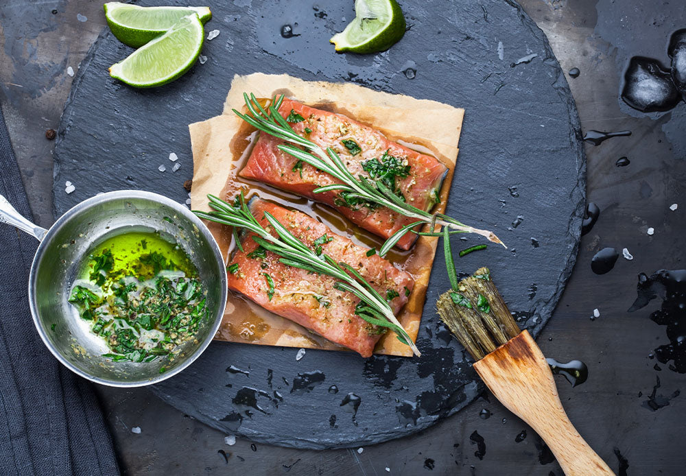 Salmon steaks marinated in fresh herbs, spices, and lime juice.