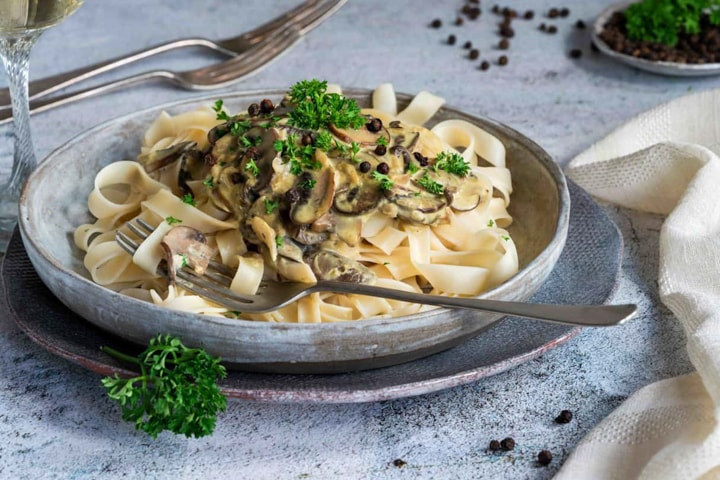 Porcini Mushrooms with Cream and Parmesan topping a bed of pasta