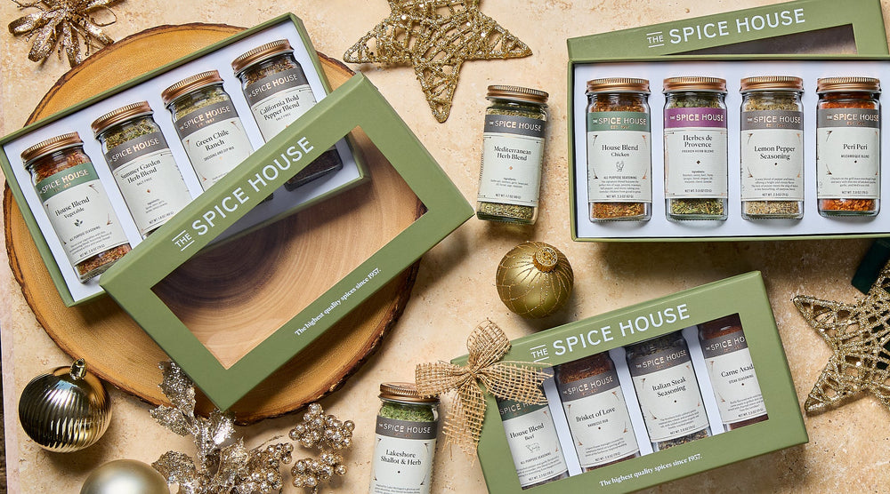 Spice House spice sets with decorative Christmas elements on a wooden surface